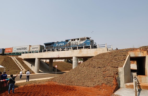 Trem passando acima e abaixo a passagem de veículos e pedestres